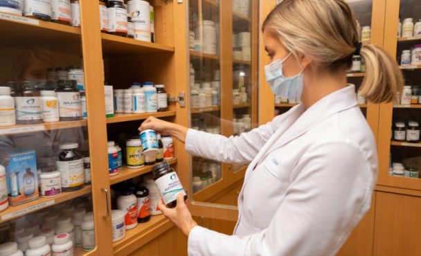 clinician taking meds from a shelf