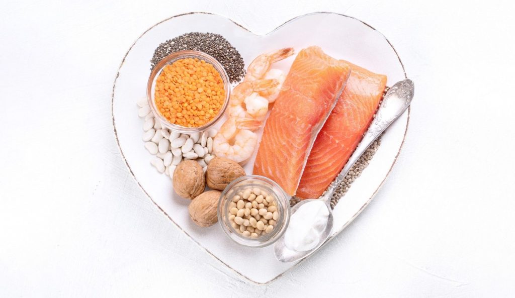 heart-shaped plate with salmon and cooking ingredients