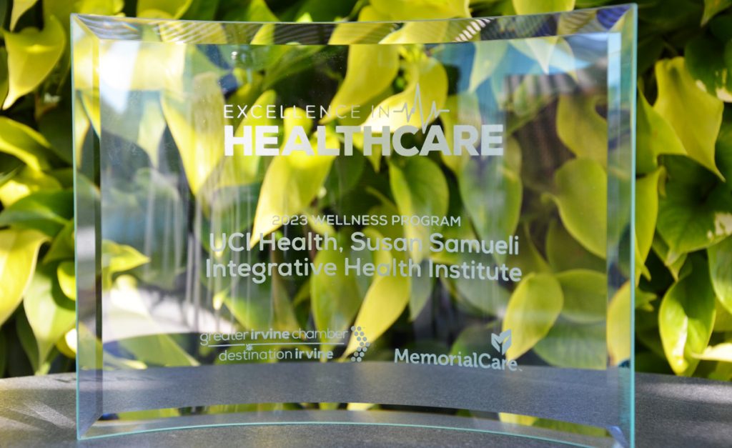 Excellence in Healthcare 2023 Wellness Program. UCI Health, Susan Samueli Integrative Health Institute award in front of living wall 