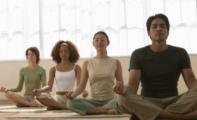 Four people seated meditating