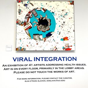 Painting with sign: "Viral Integration: An exhibit of 41 artists addressing health issues. Art is on every floor, primarily in the lobby areas. Please do not touch the works of art."